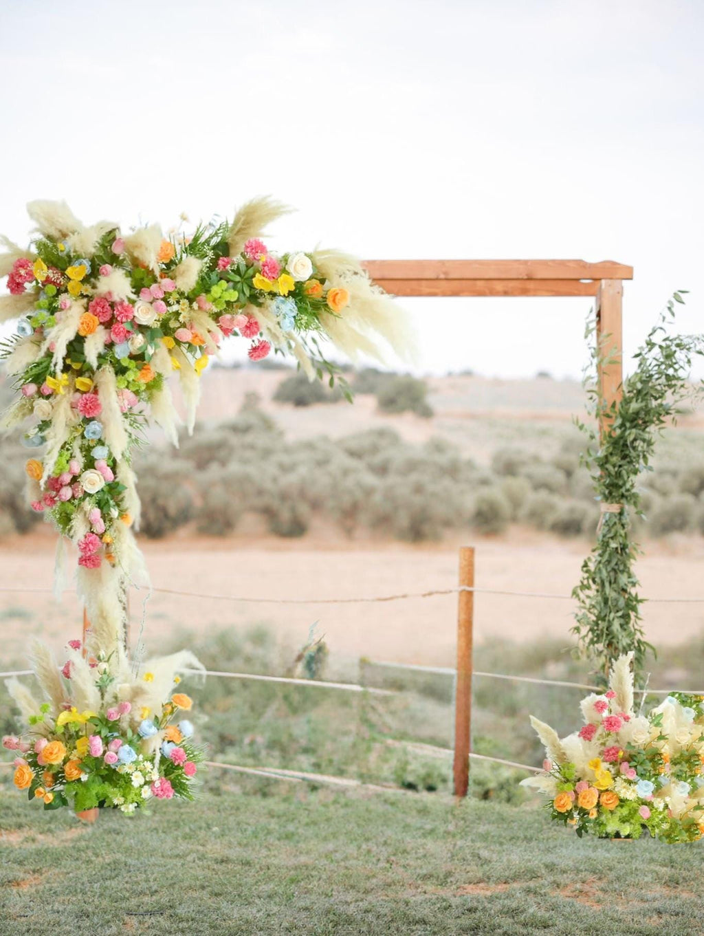 Colorful Pampas Grass Wedding Arch Flowers: Light Blue, Peach Ceremony Decor