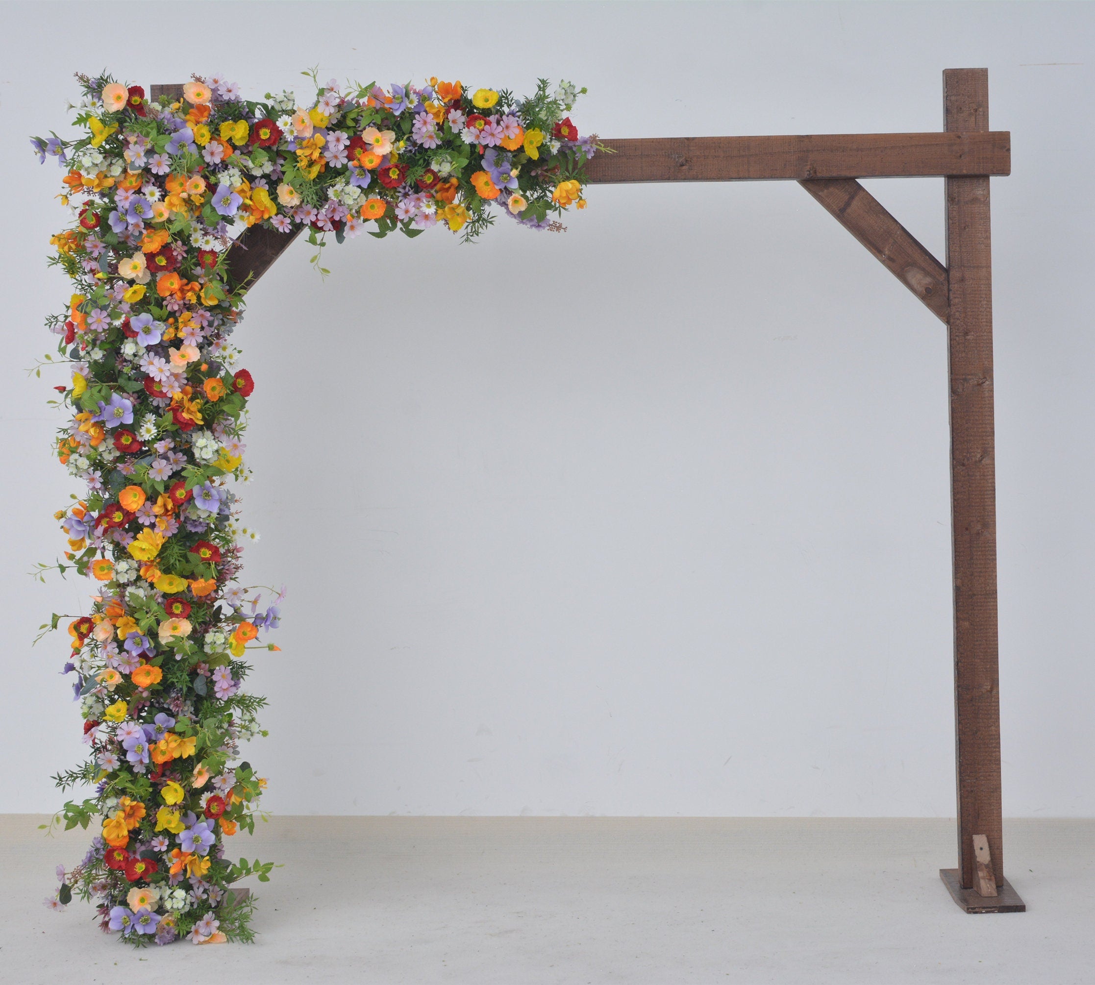Wildflower Themed Wedding Arch Arrangements in Purple, Orange, Red and Yellow