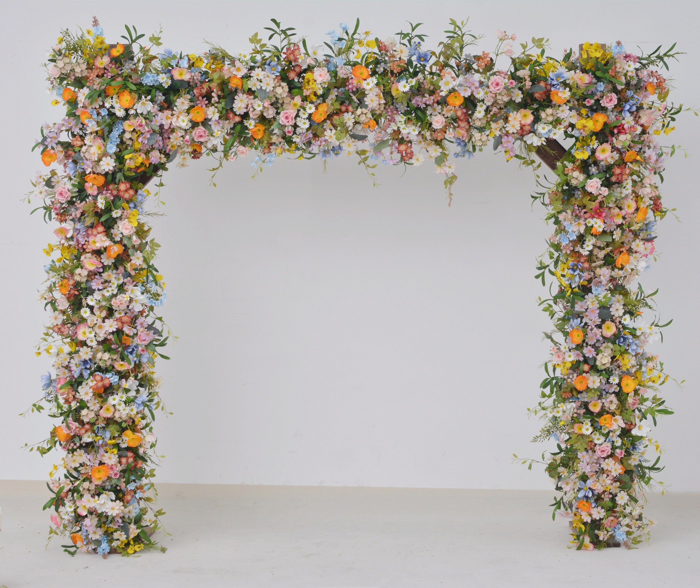 Wildflower Wedding Arbor Arrangements in Pastel Palette with a Splash of Orange and Light Blue
