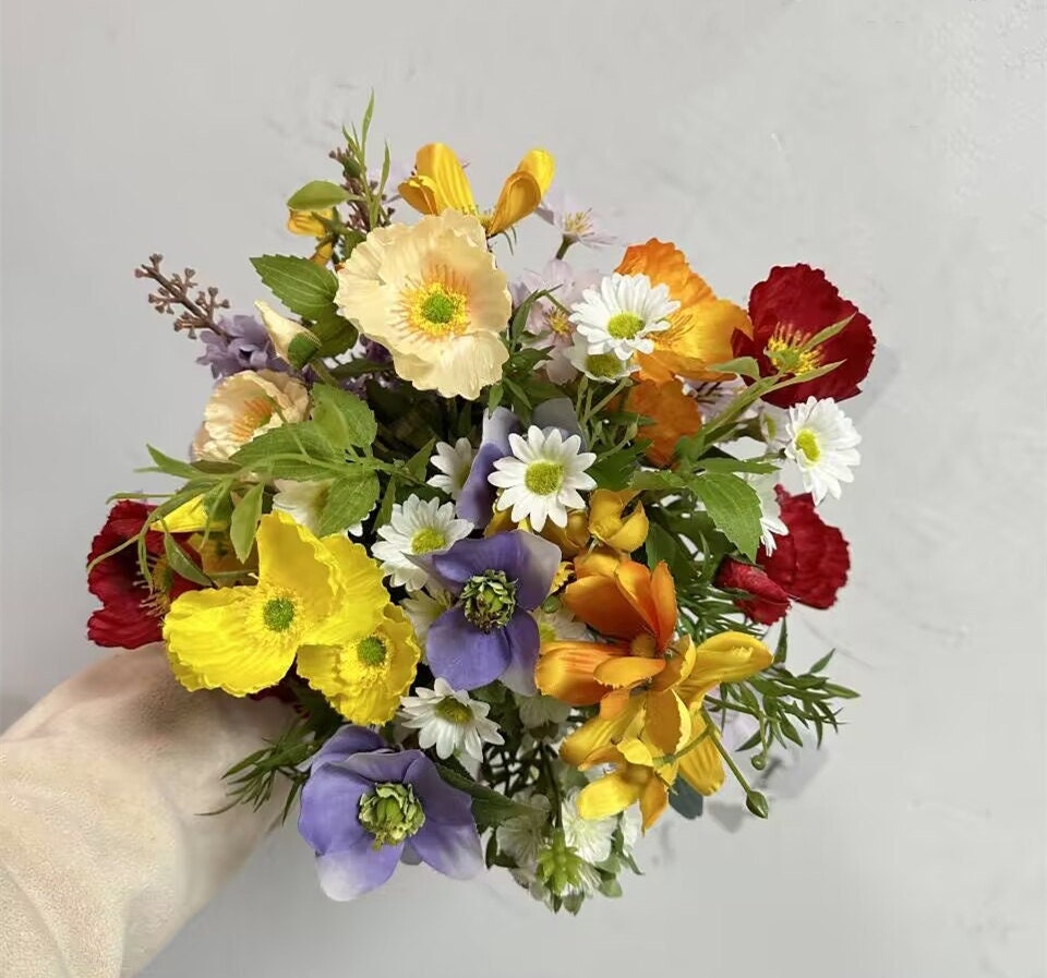 Wildflower Themed Wedding Arch Arrangements in Purple, Orange, Red and Yellow