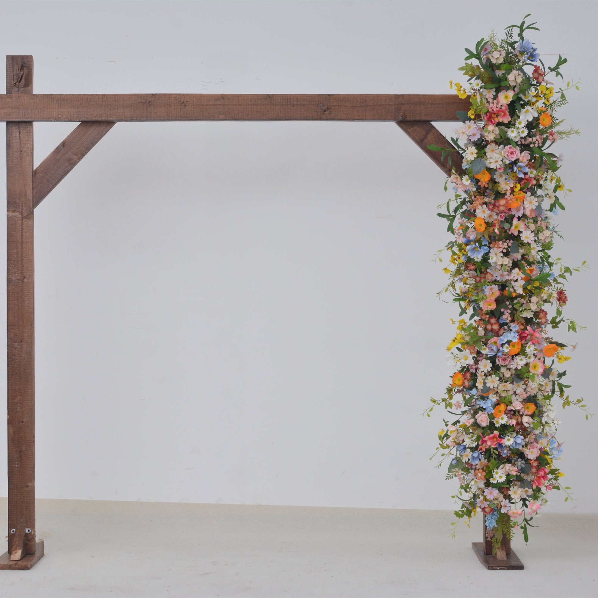 Wildflower Wedding Arbor Arrangements in Pastel Palette with a Splash of Orange and Light Blue