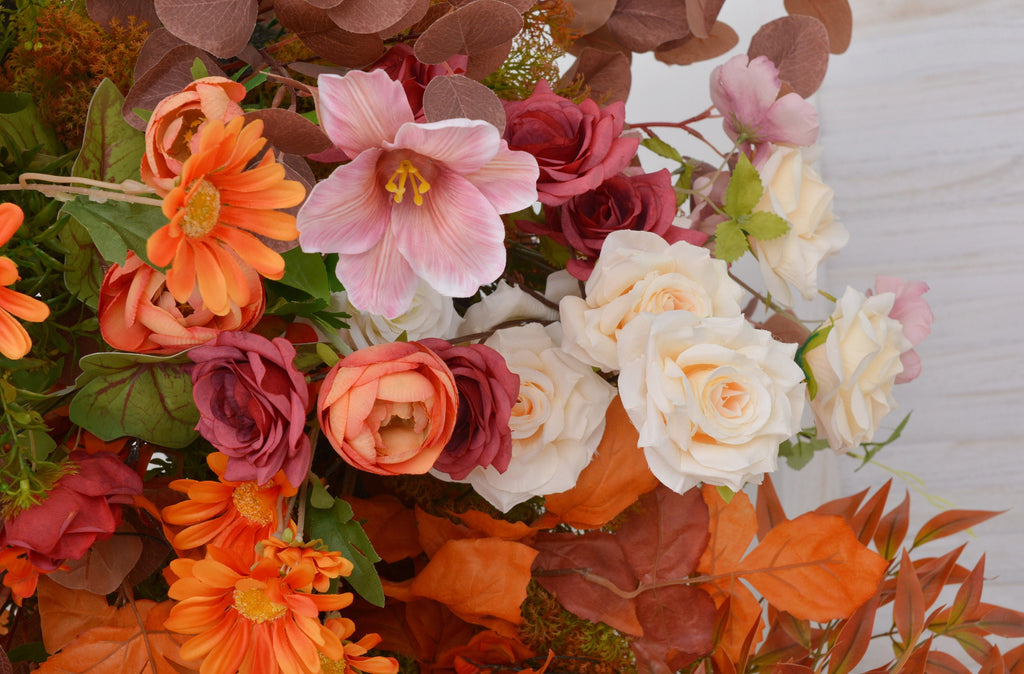 Fall Wedding Floral Arrangement with Pops of Orange, Red, and Champagne