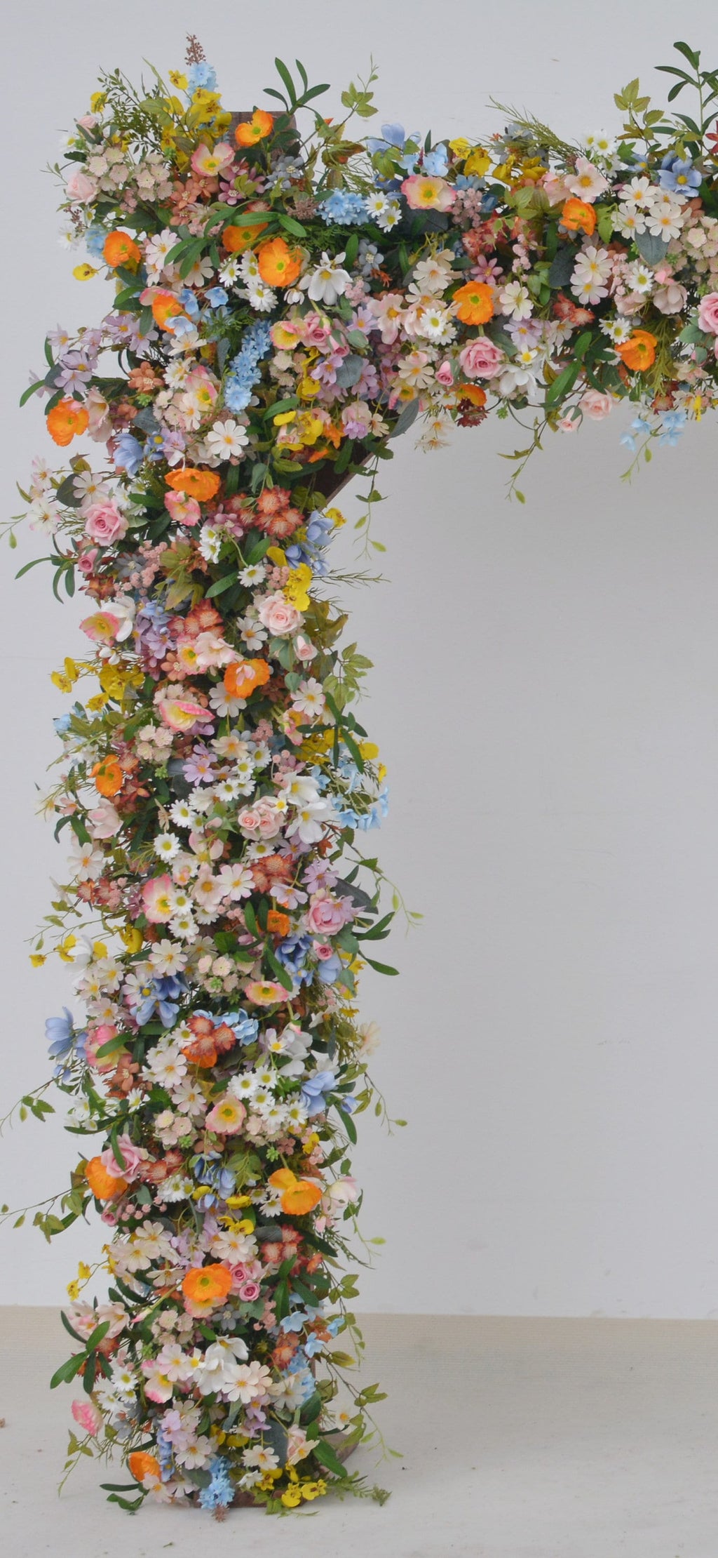 Wildflower Wedding Arbor Arrangements in Pastel Palette with a Splash of Orange and Light Blue