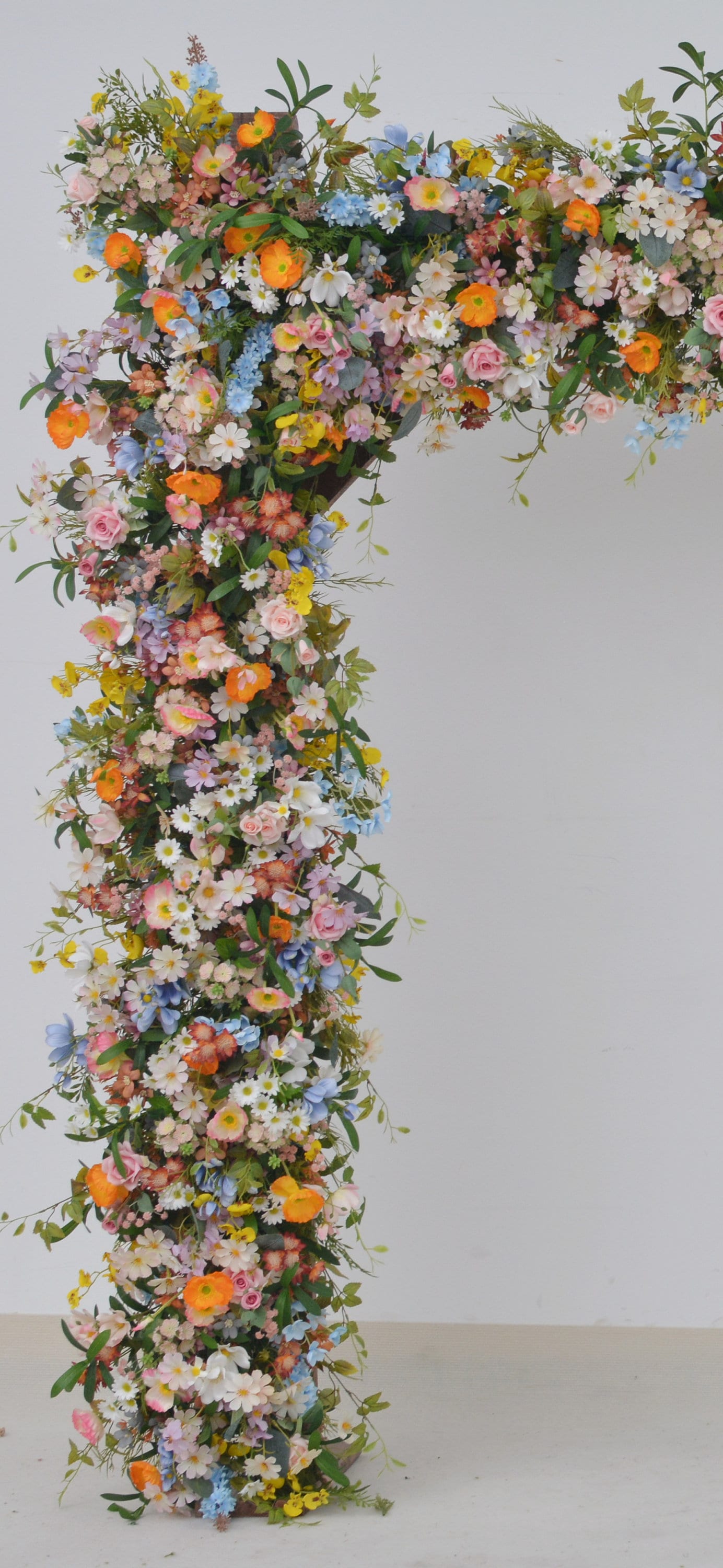 Wildflower Wedding Arbor Arrangements in Pastel Palette with a Splash of Orange and Light Blue