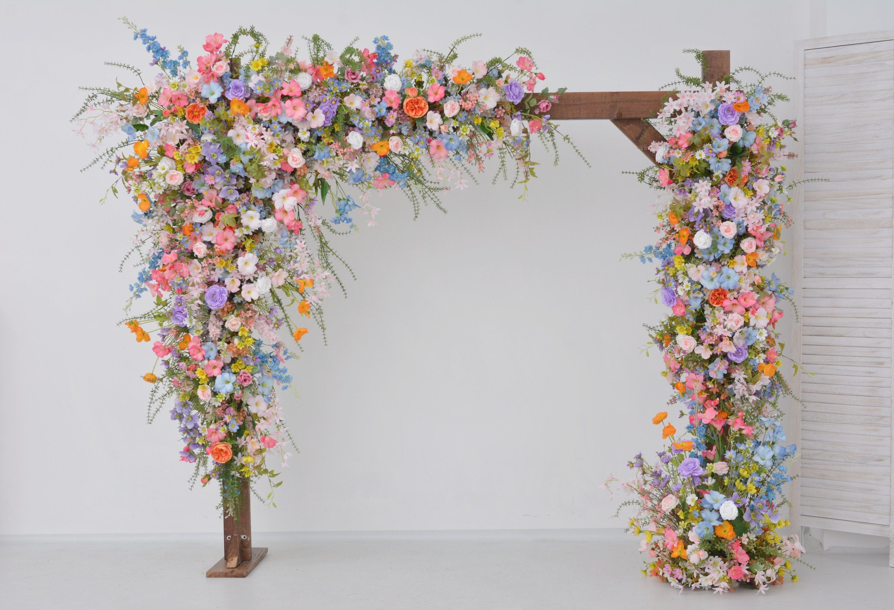 Pastel Wildflower Wedding Arbor Arrangements with Light Pink, Orange, Purple, and Blue Accents