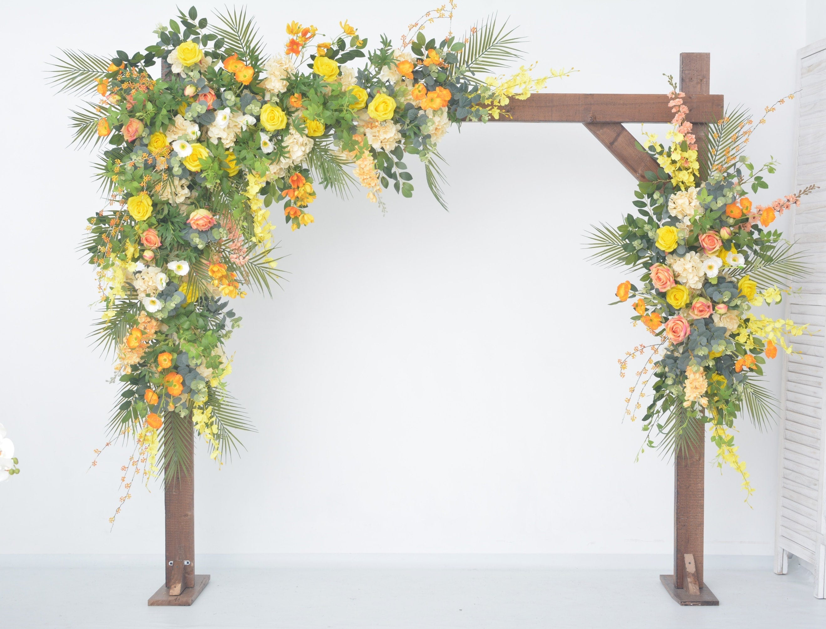 Lush Greenery Wedding Arch Decor with Yellow, Orange, and Champagne Floral Accents