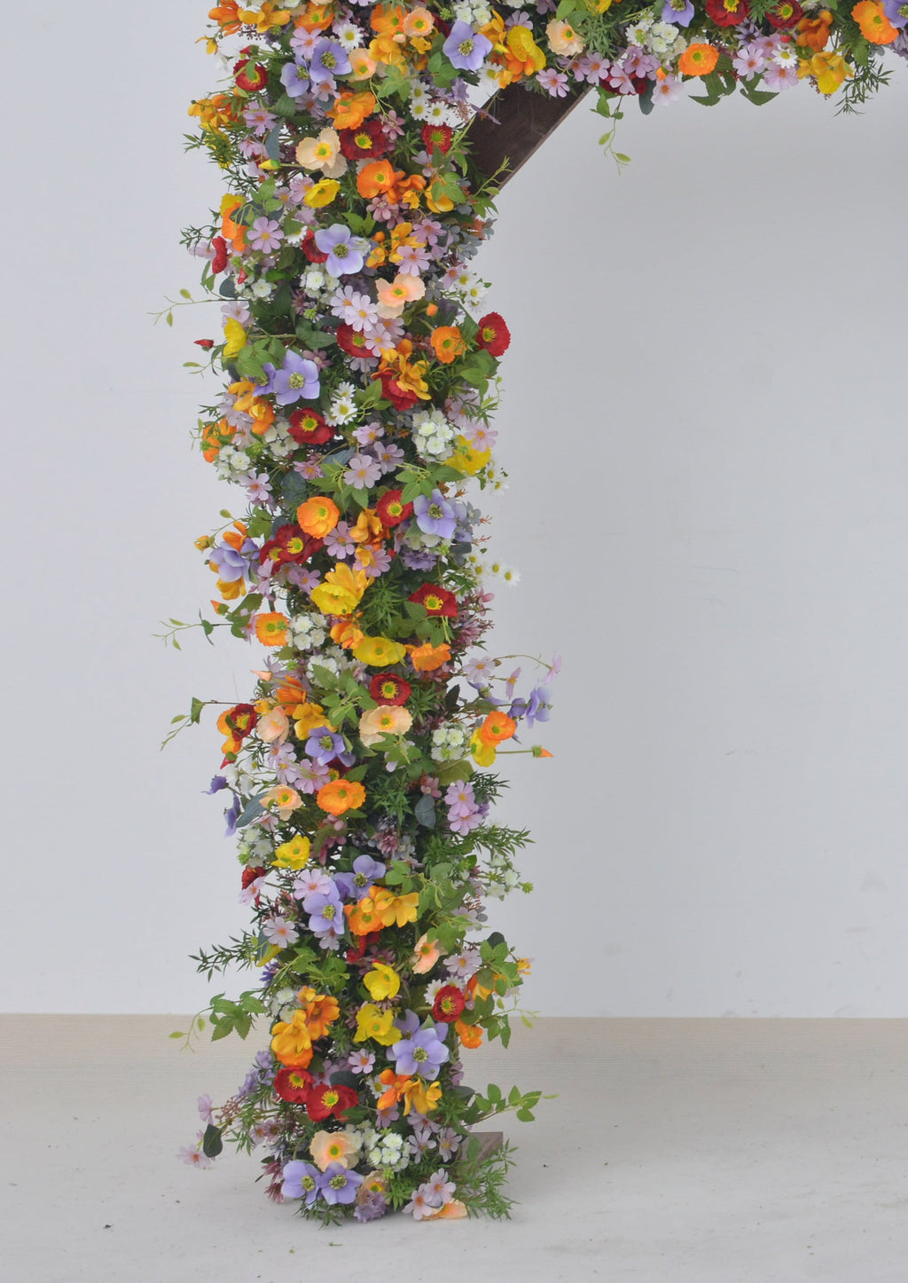 Wildflower Themed Wedding Arch Arrangements in Purple, Orange, Red and Yellow